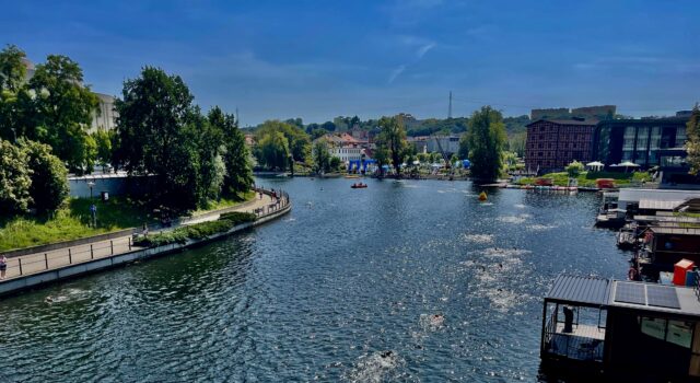 a river with boats and buildings