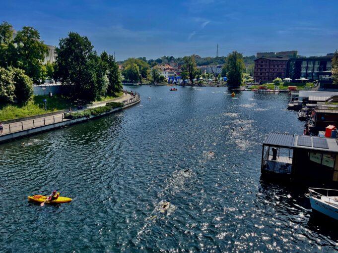 a river with boats and buildings